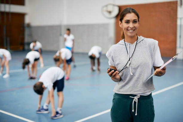 portrait of happy female physical education teacher at schoo
